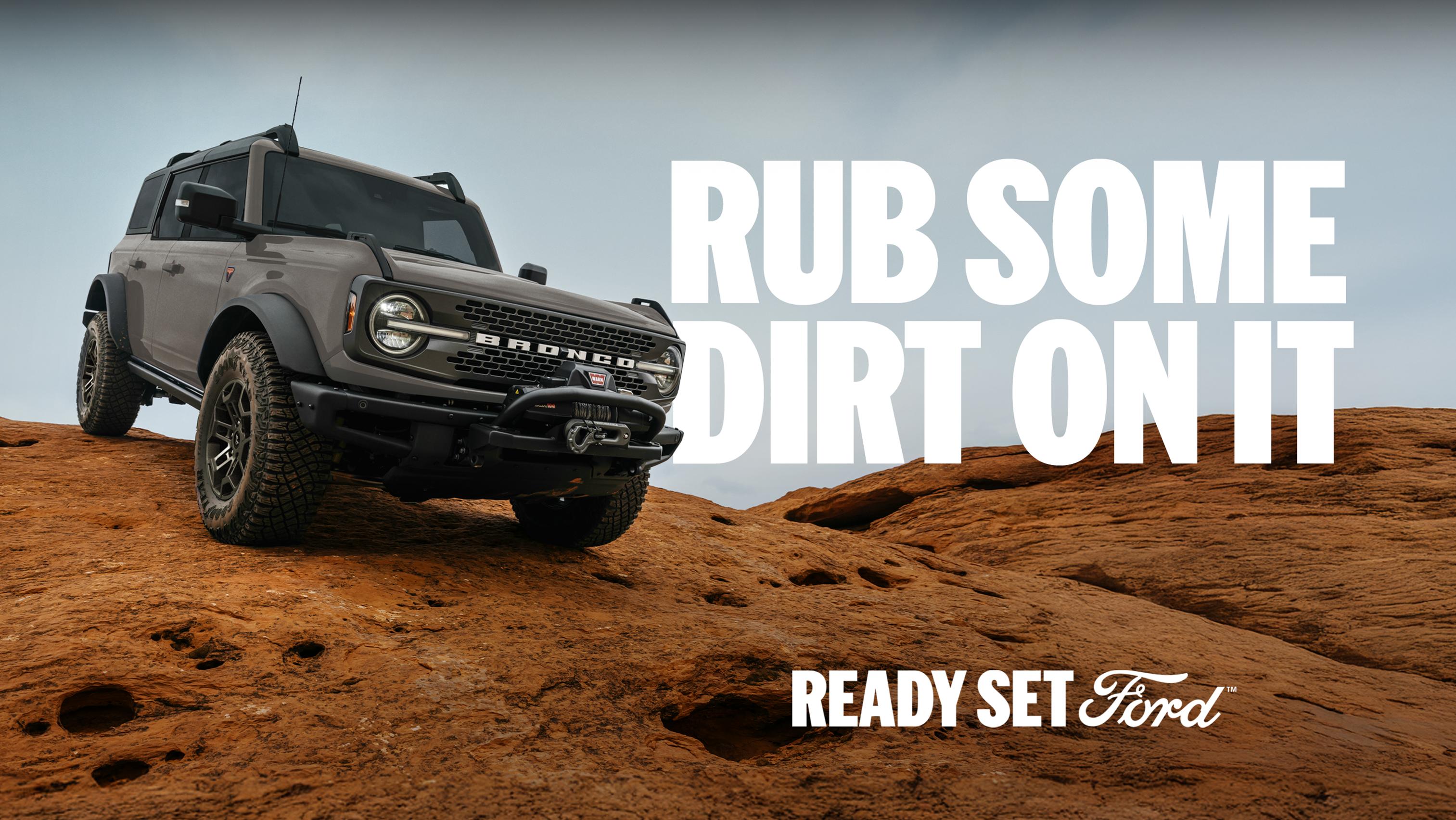 A 2026 Ford Bronco® SUV being driven down a dirt hillside